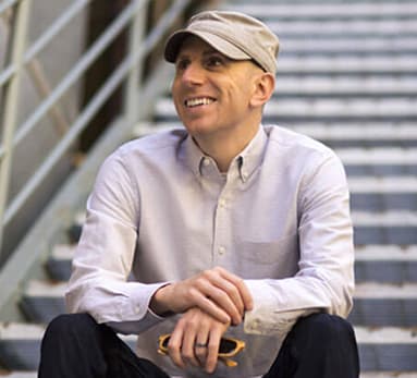 Tom Fallenstein sitting on a flight of stairs